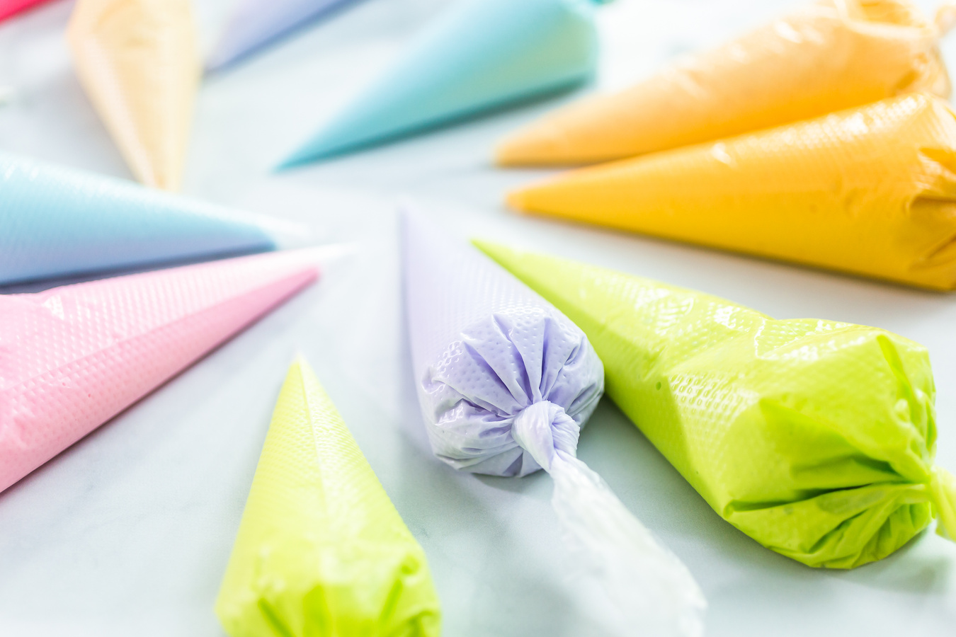 Piping bags with pastel color royal icing